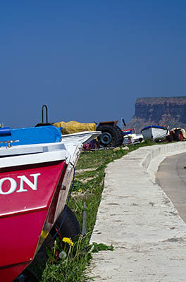 ENG: Yorkshire & Humberside Region, North Yorkshire, North Yorkshire Coast, Saltburn-by-the-Sea, Saltburn Sands. Fishing boats line up along the beach, underneath the cliffs. [Ask for #270.480.]