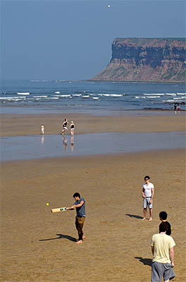 ENG: Yorkshire & Humberside Region, North Yorkshire, North Yorkshire Coast, Saltburn-by-the-Sea, Saltburn Sands. Teenagers have an informal game of cricket on the beach [Ask for #270.488.]