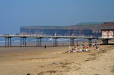 ENG: Yorkshire & Humberside Region, North Yorkshire, North Yorkshire Coast, Saltburn-by-the-Sea, Saltburn Sands and Saltburn Pier. Families enjoy the wide sand beach, cliffs in bkgd. [Ask for #270.492.]