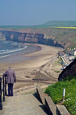 ENG: Yorkshire & Humberside Region, North Yorkshire, North Yorkshire Coast, Saltburn-by-the-Sea, Saltburn Sands and Saltburn Pier. An old man prepares to descend the ciff on concrete steps [Ask for #270.495.]