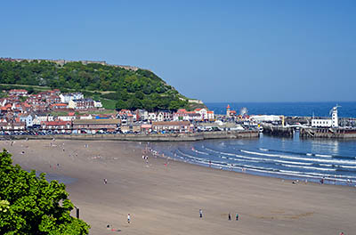 ENG: Yorkshire & Humberside Region, North Yorkshire, North Yorkshire Coast, Whitby, View from the cliffs that surround town centre over the sand beach towards the harbor [Ask for #270.529.]