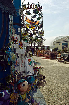 CA: South Coast Region, San Luis Obispo County, Pacific Coast Area, City of Morro Bay, Embarcadero, Gift shop by the bay  with Morro Rock in the background [Ask for #271.012.]