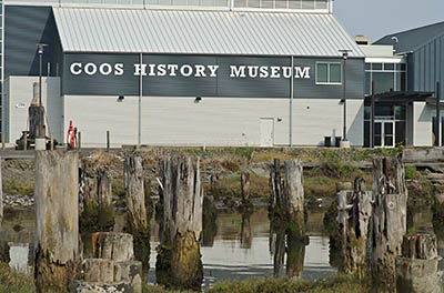 OR: South Coast Region, Coos County, Coos Bay Area, City of Coos Bay, Downtown, Waterfront, Coos Bay History Museum, Viewed over the pilings of a long-gone wharfside structure [Ask for #274.823.]