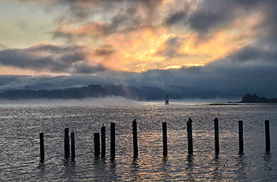 OR: South Coast Region, Coos County, Coos Bay Area, City of North Bend, Waterfront, Sunrise view from the boardwalk as a dredge deepens the channel [Ask for #276.088.]