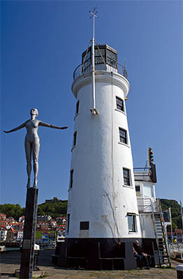 ENG: Yorkshire & Humberside Region, North Yorkshire, North Yorkshire Coast, Scarborough City, Old Harbour, Scarborough Lighthouse, with "The Diving Belle", statue celebrating Scarsborough as the UK's first seabathing resort. [Ask for #270.096.]